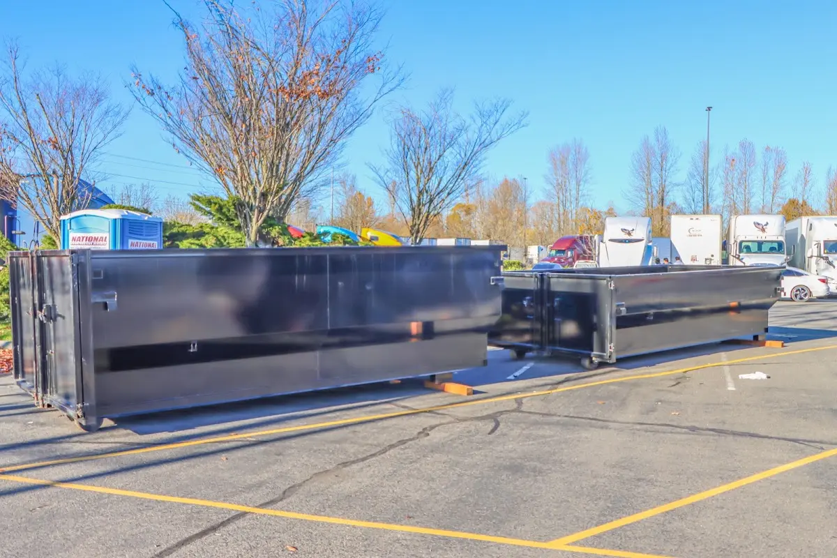 Professional dumpster rental service with roll-off container on residential driveway in Wellington